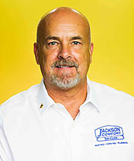 A Member Of Our Team Stands Confidently In A Crisp White Shirt.