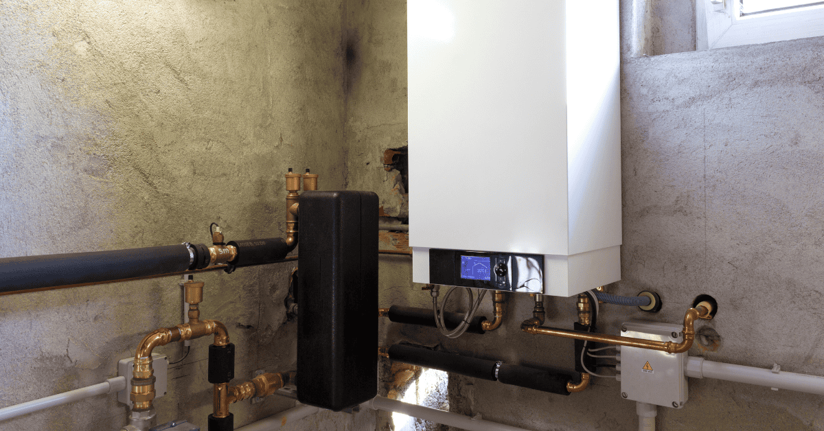 Wall-Mounted Residential Gas Boiler With Copper Supply Piping, Isolation Valves, And A Digital Control Panel